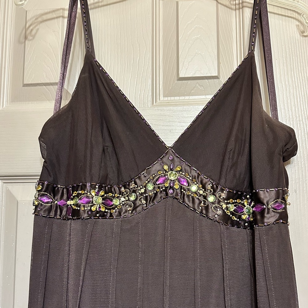 Brown cocktail mini-dress with jewel-tone embellishments on bust and straps.